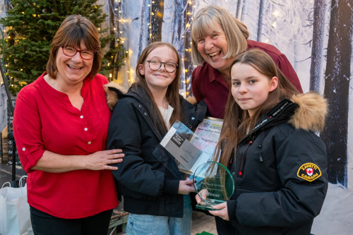 A picture of pupils from Huntingdon Academy being presented with their Best Young Gardener winners trophy and certificate